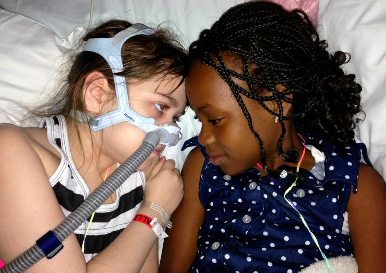 FILE - In this May 30, 2013 file photo provided by the Murnaghan family, Sarah Murnaghan, left, lies in her hospital bed next to adopted sister Ella on the 100th day of her stay in Children's Hospital of Philadelphia. A federal judge in Philadelphia has made the dying 10-year-old eligible to seek donor lungs from an adult transplant list. (AP Photo/Murnaghan Family, File)
