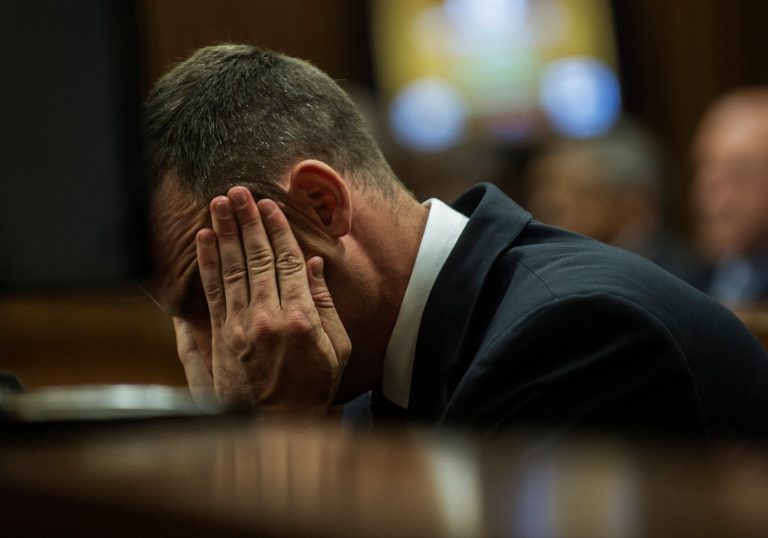Oscar Pistorius cradles his head in his hands as he listens to evidence during his murder  trial in Pretoria, South Africa, Thursday, May 8, 2014. Pistorius is charged with the shooting death of his girlfriend Reeva Steenkamp on Valentine's Day in 2013. (AP Photo/Gianluigi Guercia, Pool)