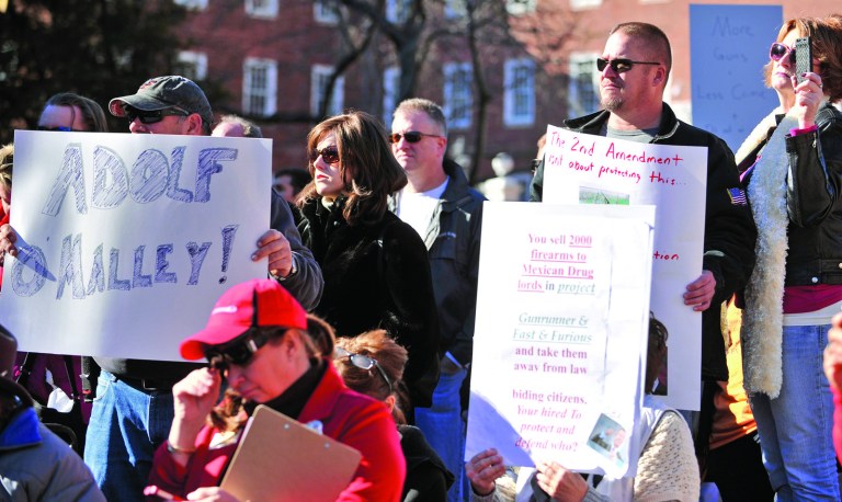 Protesters hold up signs during a protest against Governor Martin O'Malley's new gun control legislation at Lawyers Mall in Annapolis, Saturday, Jan. 19, 2013. Rallies are being held by gun rights advocates four days after President Barack Obama unveiled a sweeping plan to curb gun violence. (AP Photo/Capital Gazette, Matthew Cole)