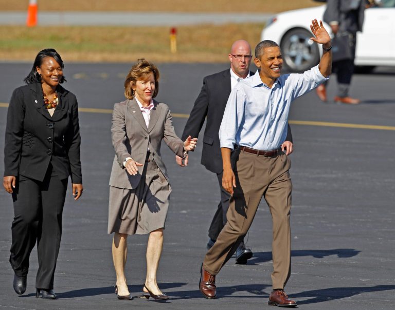 President Obama, accompanied by Sen. Kay Hagan, D-N.C., center, waves upon his arrival at the Asheville Regional Airport in Asheville, N.C., in October 2011. (AP Photo/Chuck Burton)