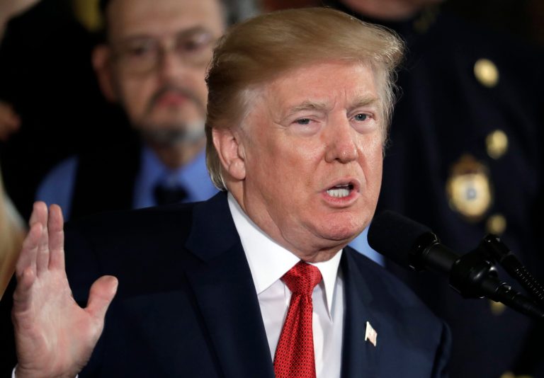 In this Oct. 26, 2017, photo, President Donald Trump speaks during an event to declare the opioid crisis a national public health emergency in the East Room of the White House in Washington. Trump and Vice President Mike Pence came out recently with statements on opioids and humanitarian aid that appear big, bold and immediate. An AP Fact Check finds there's less than meets the eye to them. (AP Photo/Evan Vucci)