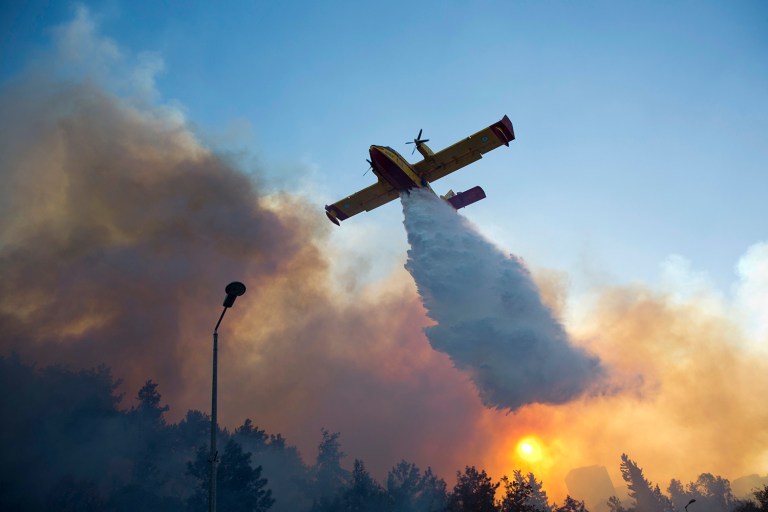 A firefighting plane fights a wildfire over Haifa, Israel, Thursday, Nov. 24, 2016. (AP Photo/Ariel Schalit)