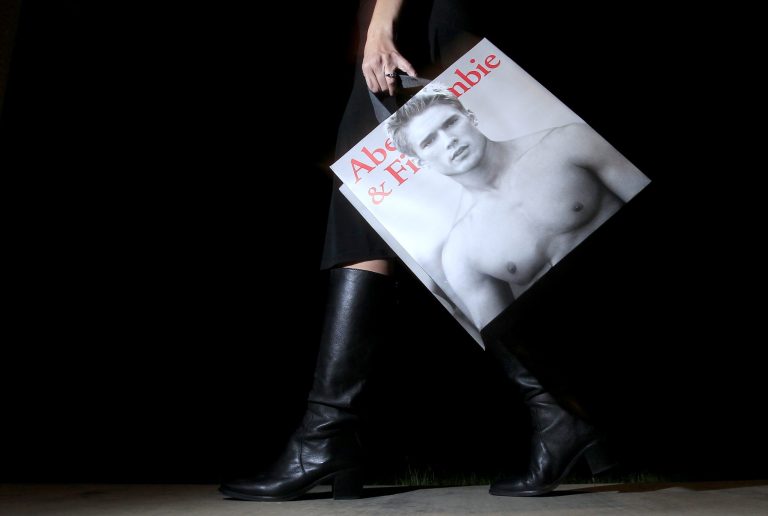 FILE - In this Nov. 14, 2011, file photo, a shopper carries her Abercrombie & Fitch purchase, in Phoenix. Shares of Abercrombie & Fitch tumbled Thursday, Aug. 28, 2014, after reporting weak sales as more teens shop elsewhere. (AP Photo/Ross D. Franklin, File)
