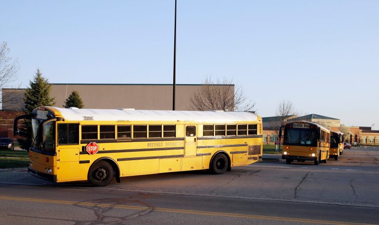 School buses leave Westfield High School after dropping off students, Friday, April 24, 2015, in Westfield, Ind.Â Thirty-nine public school districts in Indiana have an ongoing lawsuit arguing that Obamacare violates their 10th Amendment right to state sovereignty, according to the Indianapolis Star.Â (AP Photo/Darron Cummings)