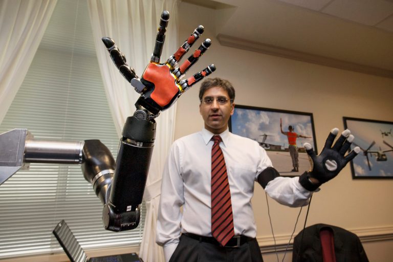 An engineer at Johns Hopkins, demonstrates a robotic hand as the Defense Advanced Research Projects Agency, DARPA, displays the latest high-tech projects being developed for wounded soldiers, Tuesday, April 22, 2014, at the Pentagon. (AP Photo/J. Scott Applewhite)