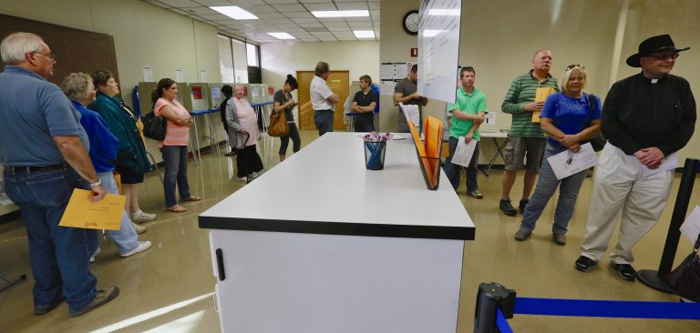 Early voters wait in line to get their ballots at the Douglas County Election Commission offices in Omaha, Neb., Friday. (AP/Nati Harnik)