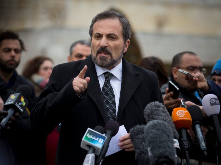 Louay Safi, center, spokesperson for the Syrian National Coalition, Syria's main political opposition group, gestures during a press briefing at the United Nations headquarters in Geneva, Switzerland, Thursday Jan. 30, 2014. Syrian negotiators have resumed their peace talks involving U.N.-Arab League mediator Lakhdar Brahimi, a day after President Bashar Assad's adviser rejected the opposition's call for a transitional governing body. (AP Photo/Anja Niedringhaus)