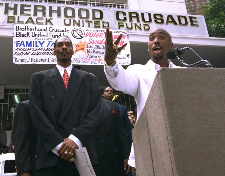 Rapper Tupac Shakur, right, speaks as fellow rap artist Snoop Doggy Dogg listens during a voter registration rally in South Central Los Angeles on August 15, 1996. Late Saturday night, September 7, 1996, Shakur and Death Row Records chairman Marion 