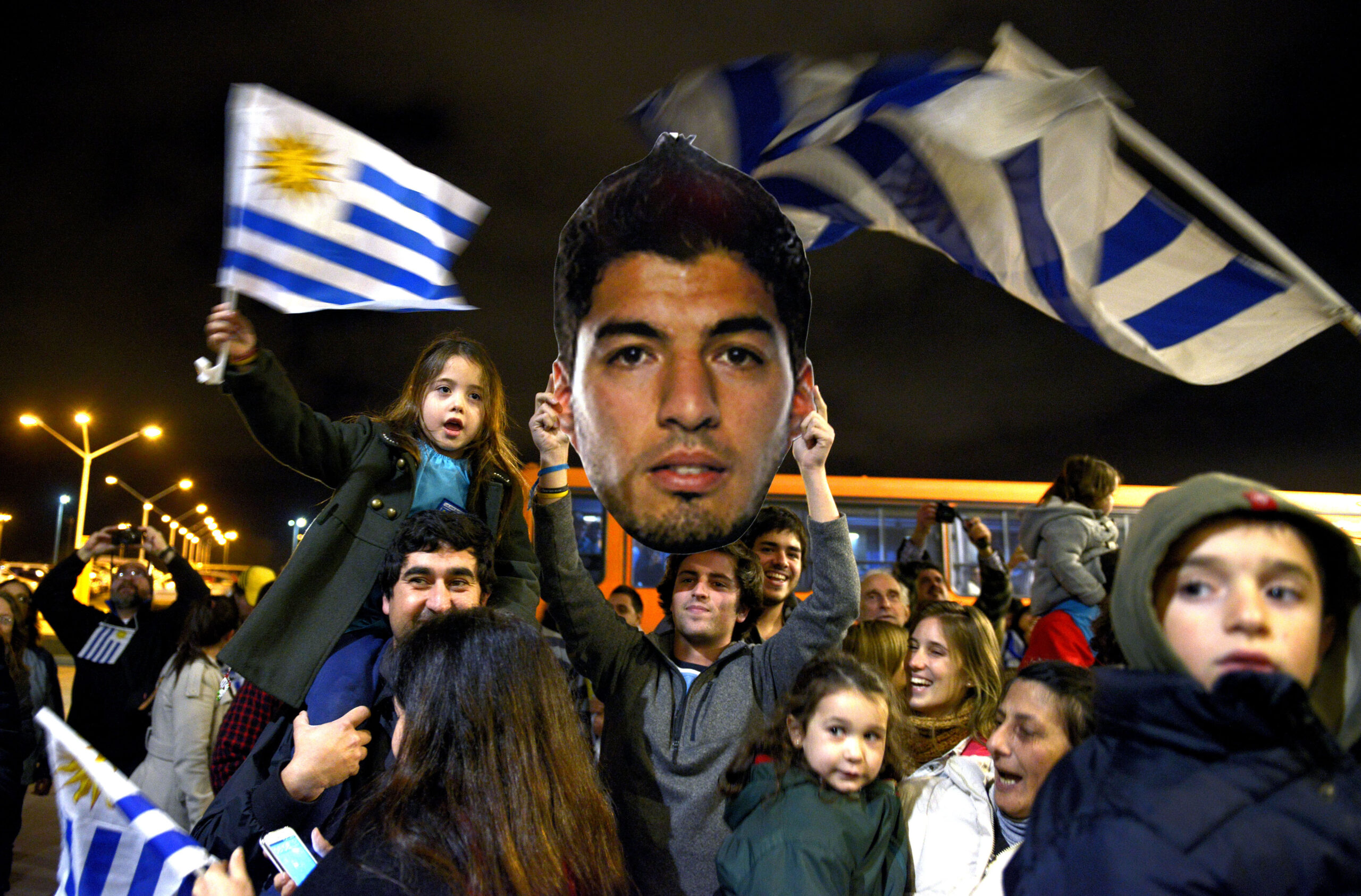 Banned Suarez back home; misses crowd in Uruguay