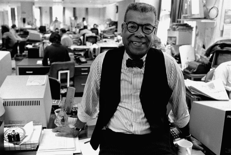 In this Feb. 15, 1984, file photo, newspaper columnist Chuck Stone poses in the newsroom of the Daily News in Philadelphia. (AP Photo/File)