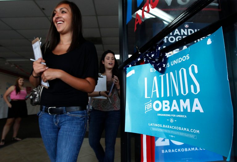 Volunteers for President Obama's reelection campaign, Carissa Valdez, right, and Vanessa Trujillo, left, as they leave campaign headquarters as they work to register new voters while they canvass a heavily Latino neighborhood shopping plaza Friday, June 29, 2012, in Phoenix. (AP Photo/Ross D. Franklin)