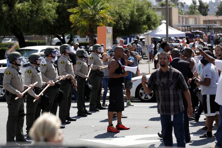 The Justice Department awards $7 million to help communities respond to violence, cop shootings (AP Photo/Gregory Bull)