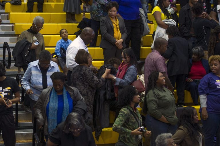 People depart the gymnasium while President Barack Obama makes a campaign speech for Maryland Democratic gubernatorial candidate Lt. Governor Anthony Brown at an Early Vote Rally at Dr. Henry Wise High School in Upper Marlboro, Md., Sunday, Oct. 19, 2014. (AP Photo/Cliff Owen)