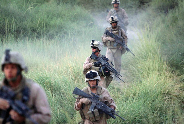 U.S. Marines, from the 24th Marine Expeditionary Unit, patrol in the town of Garmser in Helmand Province of Afghanistan Monday, July 7, 2008. (AP Photo/Rafiq Maqbool)