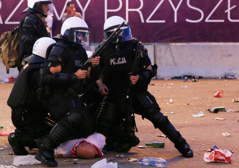   Police arrest a Polish fan during clashes between young Poles and the police during the Euro 2012 soccer championship group a match between Poland and Russia in downtown Warsaw, Poland , Tuesday, June 12, 2012. (AP Photo/Czarek Sokolowski)  