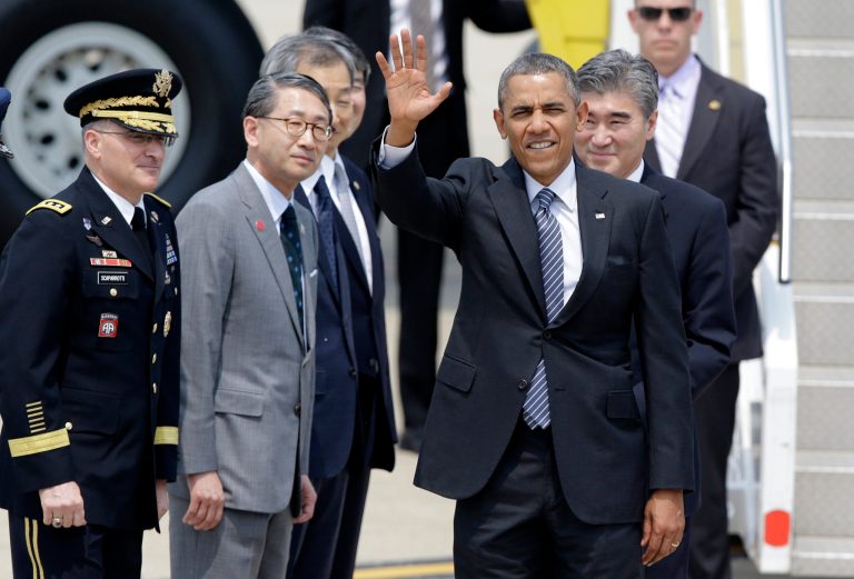 U.S. President Barack Obama waves upon his arrival for two-day visit at Osan Air Base in Pyeongtaek, south of Seoul, South Korea, Friday, April 25, 2014. (AP Photo/Lee Jin-man)