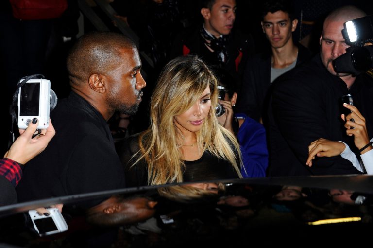 FILE - In this Sunday, Sept. 29, 2013 file photo, Kanye West, left, and Kim Kardashian leave after attending Givenchy's ready-to-wear Spring/Summer 2014 fashion collection in Paris. A photo of reality star Kim Kardashian kissing rapper Kanye West on their wedding day has broken the record for the most likes on Instagram. A European spokesperson for the photo sharing site confirms that 1.96 million likes for the shared picture from Kardashian's account is the most popular post so far. The wedding snap has over-taken a photograph shared by pop star Justin Bieber, showing actress Selena Gomez embracing him, posted five months ago which received 1.83 million likes. Kardashian and West got married on Saturday at Belvedere Fort in Florence. (AP Photo/Zacharie Scheurer, file)
