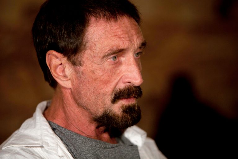   FILE - In this Dec. 4, 2012, file photo, software company founder John McAfee listens to a question during an interview at a local restaurant in Guatemala City. McAfee said Sunday, Dec. 9, 2012, a live-stream Internet broadcast from the Guatemalan detention center where he is fighting a government order that he be returned to Belize, that he wants to return to the United States and 