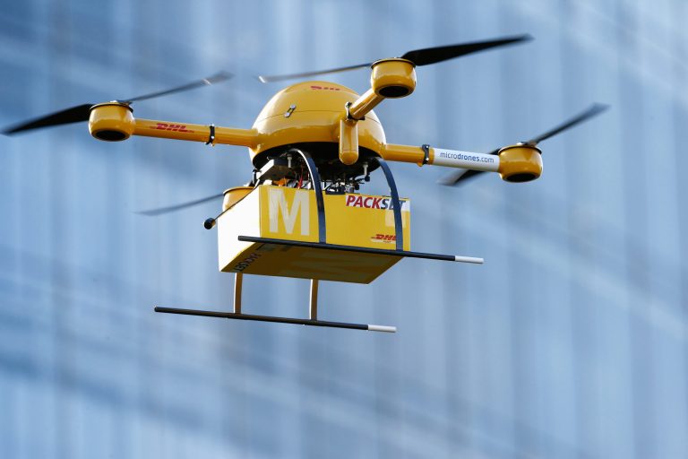 A quadcopter drone arrives with a small delivery at Deutsche Post headquarters on December 9, 2013 in Bonn, Germany. Deutsche Post is testing deliveries of medicine from a pharmacy in Bonn in an examination into the viability of using drones for deliveries of small packages over short distances. U.S. online retailer Amazon has also started its intention to explore the possibilities of using drones for deliveries. (Photo by Andreas Rentz/Getty Images)