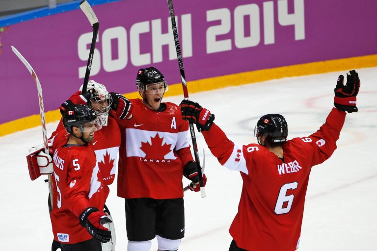 Dan Hamhuis of Canada (5), goalkeeper Carey Price of Canada (31), Jonathan Toews of Canada (16) and Shea Weber of Canada (6) celebrate their 3-0 win over Sweden in the men's gold medal ice hockey game at the 2014 Winter Olympics, Sunday, Feb. 23, 2014, in Sochi, Russia. (AP Photo/Petr David Josek)