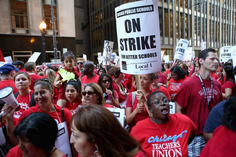 Chicago public school teachers and their supporters picket in front of the Chicago Public Schools headquarters on Sept. 11, 2012, in Chicago, Illinois. 