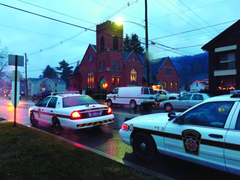 Police cars are parked at the 180-year-old First United Presbyterian Church of Coudersport Sunday morning, Dec. 2, 2012, where church organist Darlene Sitler, 53, was shot to death by her ex-husband Gregory Eldred, 52, during a worship service. Eldred, an elementary school music teacher, walked into the church in the middle of Sunday services and shot and killed his ex-wife as she sat in a pew, police said. (AP Photo/The Bradford Era, Amanda Jones)