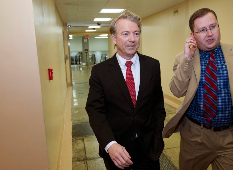 Sen. Rand Paul, R-Ky., walks with aide Sergio Gor to the Senate chamber Thursday to challenge the massive spending budget eventually approved by Congress. (AP Photo/Jose Luis Magana)