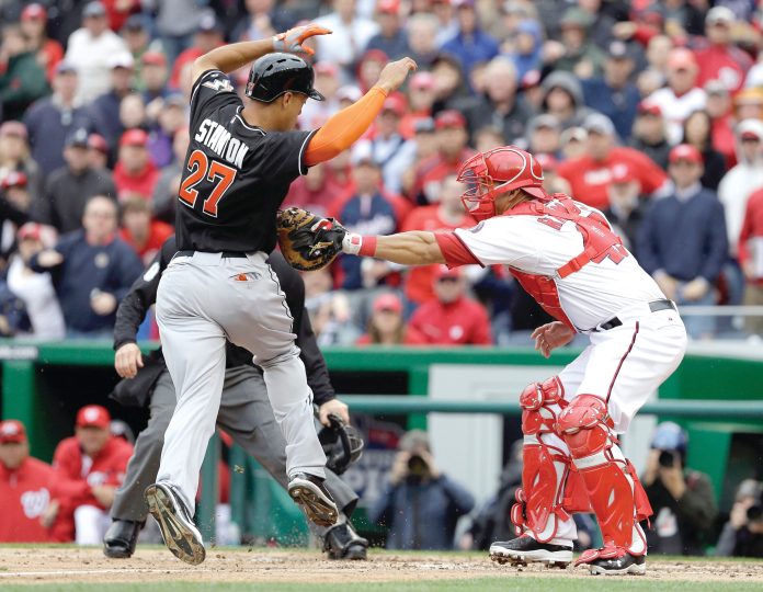 Rob Carr/Getty Images
Wilson Ramos went 1-for-2 with a walk and tagged out Giancarlo Stanton at home plate in his first game since surgery to repair a torn ACL and meniscus.