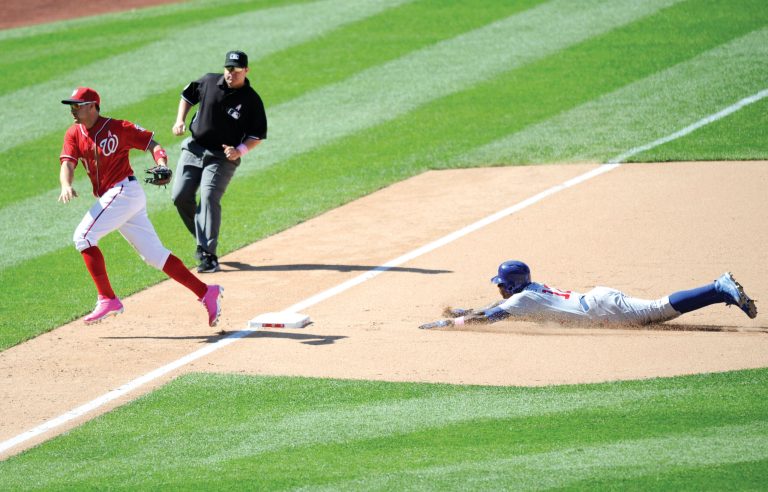 Nick Wass/AP
Nationals third baseman Ryan Zimmerman runs after the ball after Kurt Suzuki made an error attempting to catch Cubs outfield Alfonso Soriano stealing. Soriano scored on the error.