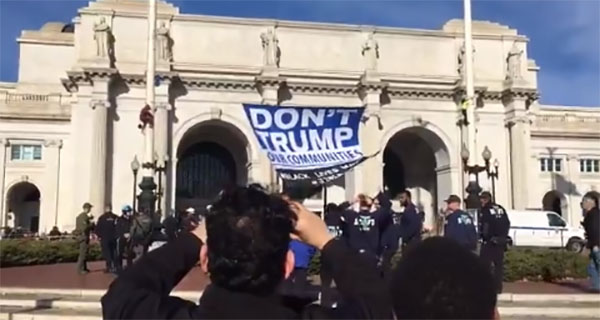 After climbing up flagpoles, the protesters hung up a sign that read: 