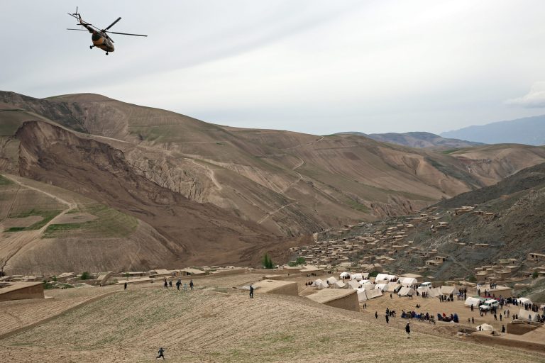 Survivors walk near the site of Friday's landslide that buried Abi-Barik village in Badakhshan province, northeastern Afghanistan, Sunday, May 4, 2014. As Afghans observed a day of mourning Sunday for the hundreds of people killed in a horrific landslide, authorities tried to help hundreds of families displaced by the torrent of mud that swept through their village. (AP Photo/Massoud Hossaini)