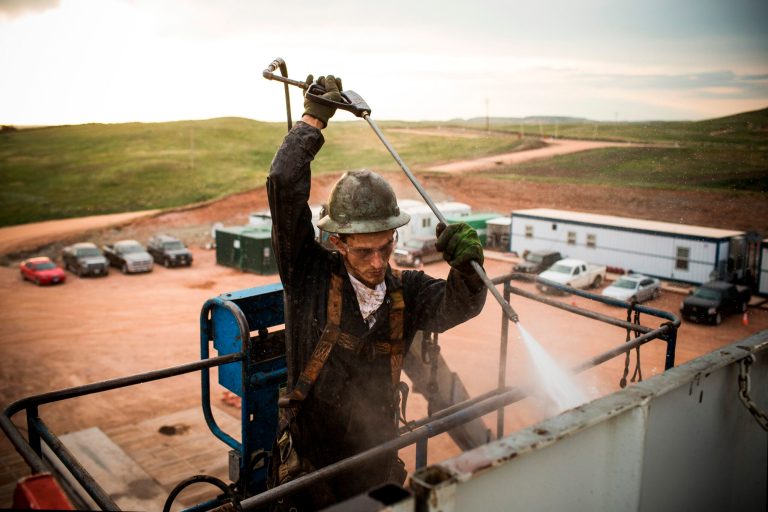 A floor hand for Raven Drilling works on an oil rig drilling into the Bakken shale formation outside Watford City, N.D. (Andrew Burton/Getty Images)