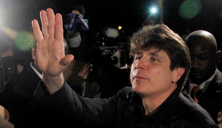 In this March 15, 2012 file photo, former Illinois Gov. Rod Blagojevich waves as he departs his Chicago home for Littleton, Colo., to begin his 14-year prison sentence on corruption charges. (AP Photo/Charles Rex Arbogast, File)