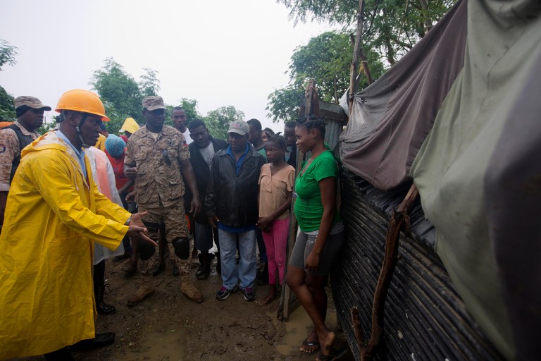 A civil protection worker asks residents to evacuate the area near the Grise river, prior the arrival of Hurricane Matthew, in Haiti. (AP Photo/Dieu Nalio Chery)