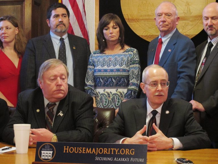 Rep. Mike Hawker, seated right, addresses reporters after the Alaska Legislature passed a bill in Juneau, Alaska on Saturday, April 13, 2013 meant to advance an in-state gas pipeline project. Seated beside him is House Speaker Mike Chenault. Chenault and Hawker were the prime sponsors of HB4. Also shown standing from left are Reps. Lindsey Holmes, Pete Higgins, Charisse Millett, Steve Thompson and Doug Isaacson. (AP Photo/Becky Bohrer)