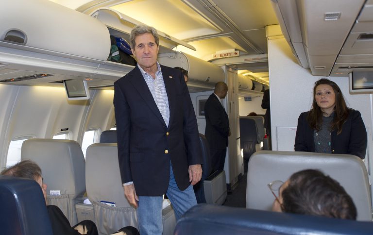 U.S. Secretary of State John Kerry talks to reporters traveling abroad with him shortly after finding out their aircraft had a mechanical problem before take off Saturday, April 6, 2013, at Andrews Air Force Base in Maryland. A backup aircraft was brought in to replace the plane. (AP Photo/Paul J. Richards, Pool)