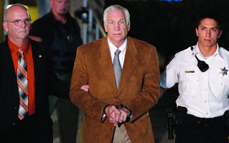 FILE - In this June 22, 2012 file photo, former Penn State University assistant football coach Jerry Sandusky, center, leaves the Centre County Courthouse in custody after being found guilty of multiple charges of child sexual abuse in Bellefonte, Pa. A judge announced Monday, Sept. 17, 2012, he will sentence Jerry Sandusky on Oct. 9, nearly four months after the retired assistant football coach was convicted in the child molestation scandal that brought shame to Penn State. (AP Photo/Gene J. Puskar, File)