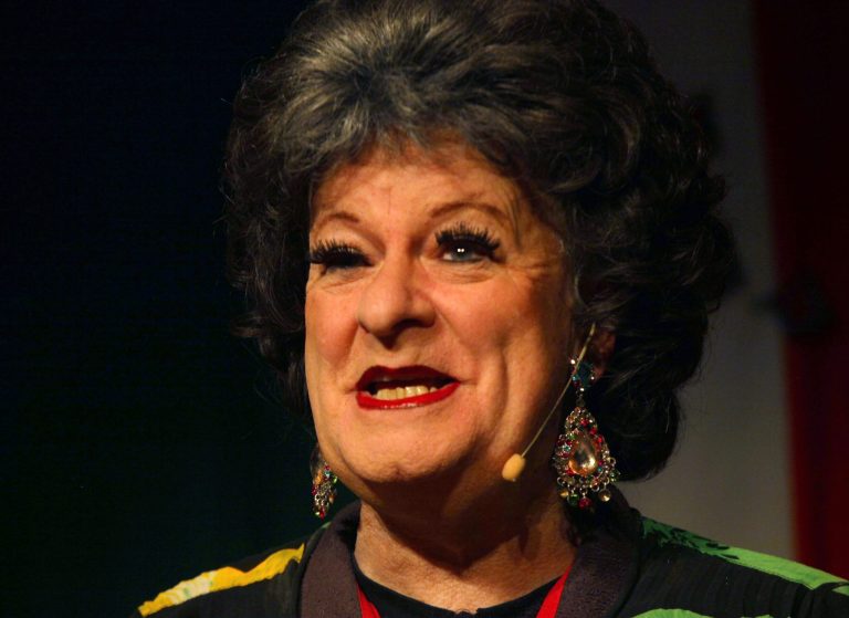 Cross-dressing South African satirist, Pieter-Dirk Uys, speaks to journalists as Evita Bezuidenhout, at Johannesburg's Market Theatre, Tuesday Sept. 30, 2014, where he is launching a four-week run of 