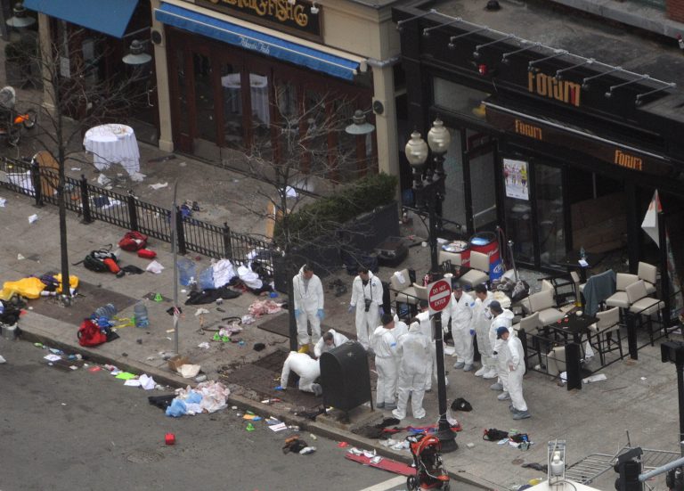 BOSTON - APRIL 16:  Investigators in white jumpsuits work the crime scene on Boylston Street following yesterday's bomb attack at the Boston Marathon April 16, 2013 in Boston, Massachusetts. Security is tight in the City of Boston following yesterday's two bomb explosions near the finish line of the Boston Marathon, that killed three people and wounding hundreds more.  (Photo by Darren McCollester/Getty Images)