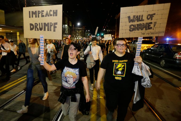 Protesters call for the impeachment of President-elect Donald Trump as they march Wednesday, Nov. 9, 2016 in Seattle. A day after Trump's election as president, the divisions he exposed only showed signs of widening as many thousands of protesters flooded streets across the country to condemn him. (AP Photo/Ted S. Warren)