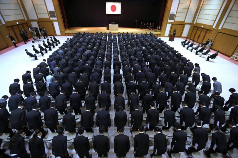 New ministry workers bow during a welcome ceremony for them at Defense Ministry in Tokyo, Tuesday, April 1, 2014. Japan relaxed a decades-old ban on military-related exports Tuesday in a bid to expand joint arms development with allies and equipment sales to Southeast Asia and elsewhere. (AP Photo/Eugene Hoshiko)