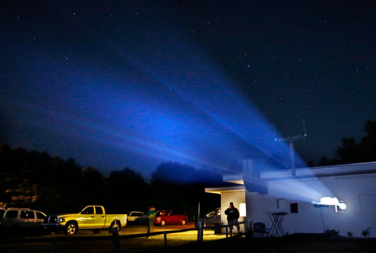 In this photo made Thursday, June 26, 2014, light from a digital projector beams from the projection house at the Saco Drive-In in Saco, Maine. Drive-in movie theater operators say more than 200 of the remaining 348 drive-ins in the country have made the costly switch from film to digital. (AP Photo/Robert F. Bukaty)