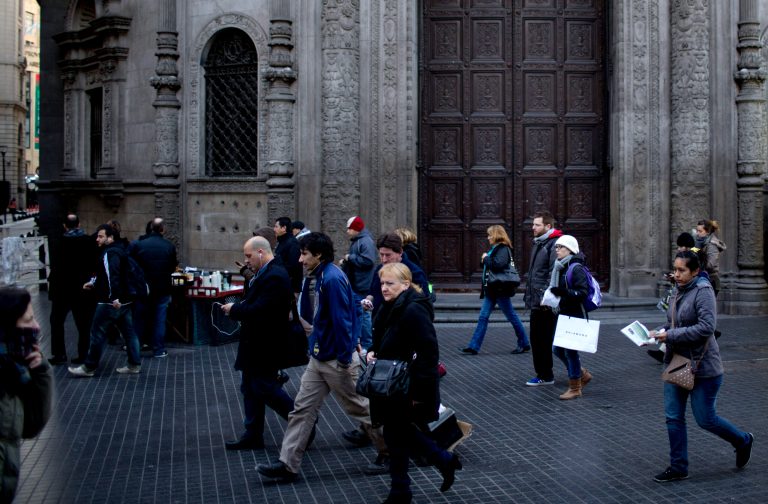 In this Friday, July 25, 2014 photo, pedestrians walk past a branch of the Industrial and Commercial Bank of China, a target for anti-capitalist agitation ever since a 1927 anarchist bombing of what was then a Bank of Boston, in Buenos Aires, Argentina. In 2001, this neo-colonial bank building from Argentina's golden age was ground zero for the country's financial earthquake. Mobs of protesters stared down riot police to demand the return of their savings confiscated by the government in a last-ditch, and ultimately failed, attempt to stay current on its debt. Thirteen years later, a July 30th midnight deadline approaches to avert another default. (AP Photo/Natacha Pisarenko)
