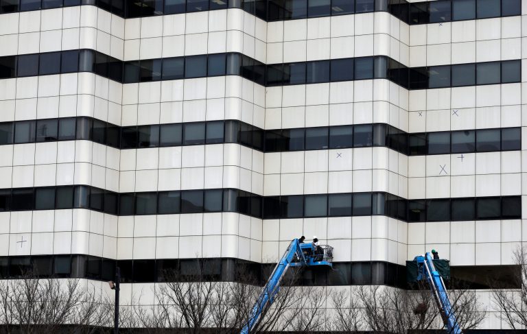 In this Monday, Jan. 20, 2014 photo, workers use bucket lifts as they work on an office building, in Trenton, N.J.  The Commerce Department releases construction spending for December on Monday, Feb. 3, 2014. (AP Photo/Mel Evans)