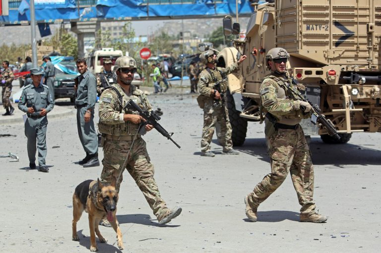 NATO and Afghan security forces walk at the site of a suicide attack in Kabul, Afghanistan, Sunday, Aug. 10, 2014. (AP Photo/Rahmat Gul)