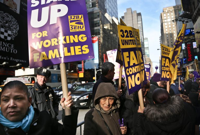   FILE - In this Wednesday, Dec. 12, 2012 file photo, cleaners, porters and matrons of theater union SEIU Local 32BJ demonstrate outside the Broadway League's office, before a vote authorizing a strike in New York. The union representing hundreds of Broadway theater cleaners, porters, elevator operators and bathroom attendants has reached a tentative labor agreement with the Broadway League to avert a strike. The potential deal, announced Monday, Dec. 17, 2012, must be ratified by the 250 theater workers represented by 32BJ, a process expected soon. (AP Photo/Bebeto Matthews, File)  