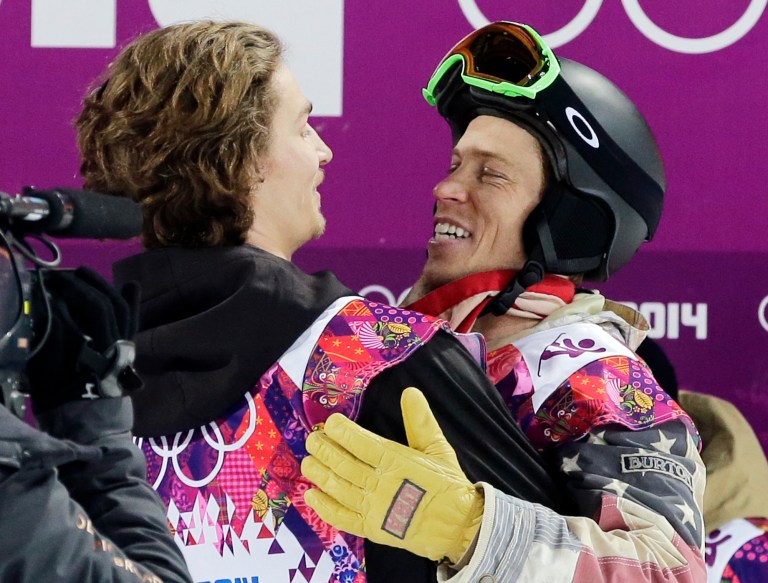 Switzerland's Iouri Podladtchikov, left, celebrates with Shaun White of the United States after  Podladtchikov won the gold medal in the men's snowboard halfpipe final at the Rosa Khutor Extreme Park, at the 2014 Winter Olympics, Tuesday, Feb. 11, 2014, in Krasnaya Polyana, Russia. (AP Photo/Andy Wong)