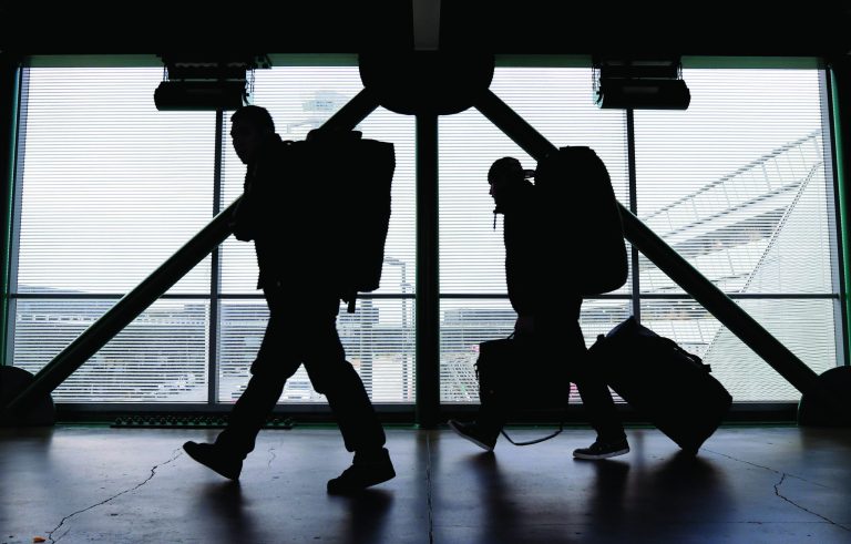 FILE - This Dec. 21, 2012 file photo shows travelers walking to a ticketing desk at O'Hare International Airport in Chicago. For many passengers, air travel is only about finding the cheapest fare. But as airlines offer a proliferating list of add-on services, from early boarding to premium seating and baggage fees, the ability to comparison-shop for the lowest total fare is eroding. (AP Photo/Nam Y. Huh, File)