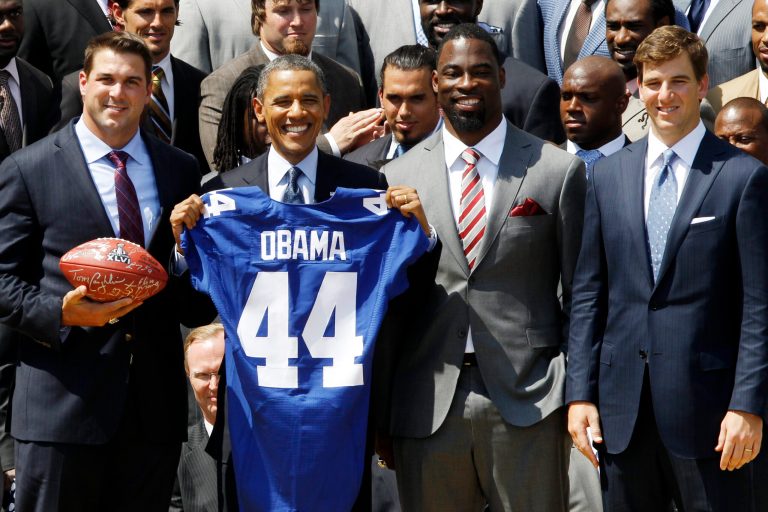   President Barack Obama poses with New York football Giants captains, from left: Zak DeOssie; Justin Tuck; Eli Manning, on the South Lawn at the White House in Washington, Friday, June 8, 2012, during a ceremony where the president honored the Super Bowl XLVI champions New York Giants. (AP Photo/Charles Dharapak)  