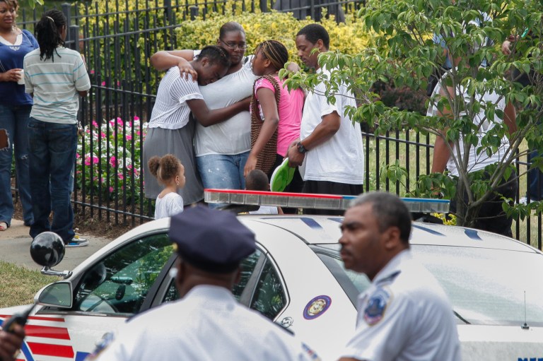 A group of women hug after a shooting Monday in Southeast D.C. (Graeme Jennings/Examiner)